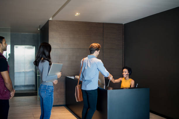 istock Young people in line at reception desk 948307124
