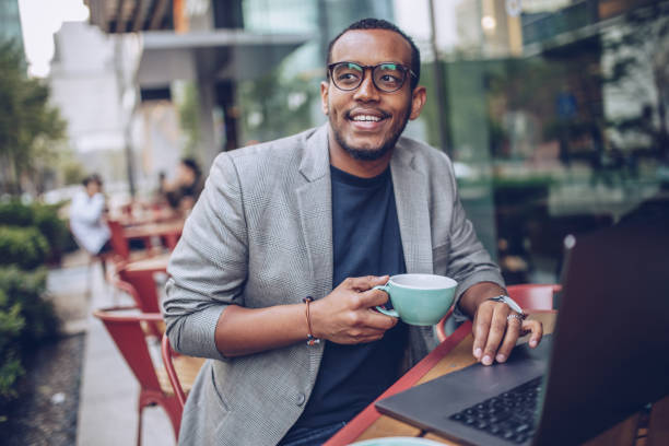 istock Handsome man in coffee shop using laptop 948316754