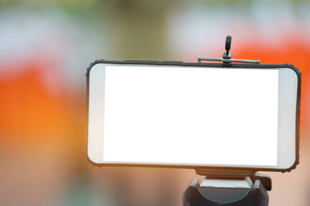 istock LCD Screen Blank smartphone on Tripod for copy space in your text message or promotional content, advertising mock up empty insert for coutomer Background. 948316788