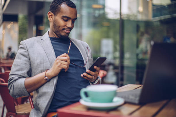 istock Man sitting in coffee shop and texting 948317518