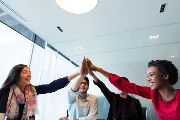 istock Young professionals sitting and putting hands together 948318224