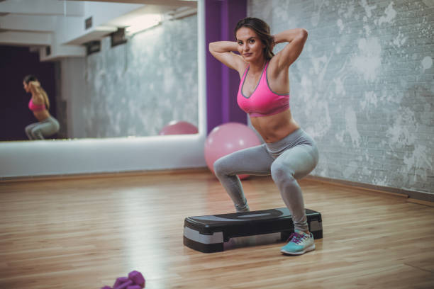 istock Beautiful woman exercising in gym 948324686