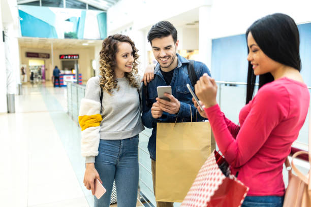 istock Couple doing shopping and using smart phone in mall 948328782
