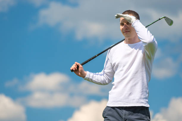 istock golfer with a golf club on a sunny day against a blue sky 948328824