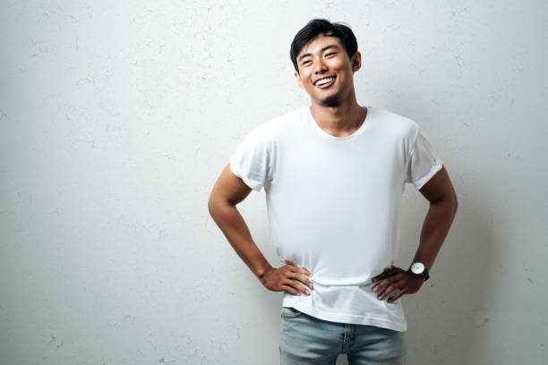 Handsome asian man in white blank t-shirt stock photo