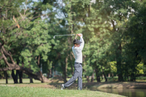 istock Golfers asia man show hit sweeping at green lawn 948333598