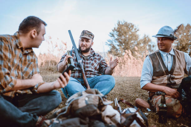 istock Group of Hunters Taking Break from Hunting and Drinking 948351836