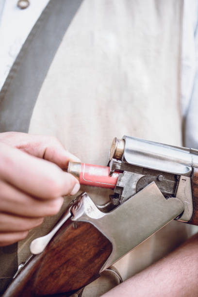 istock Close up of Hunter Putting Bullets in his Gun 948352018