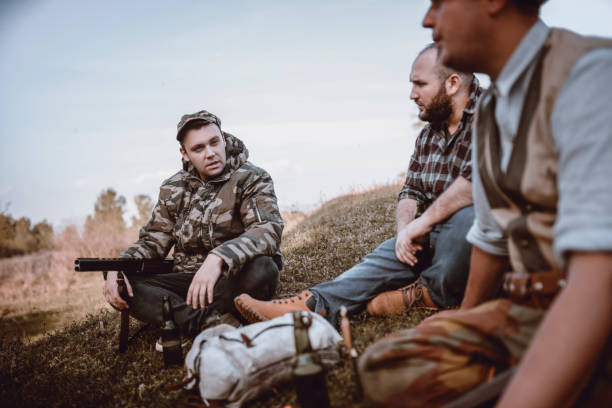 istock Group of Hunters Taking Break from Hunting and Talking 948354968