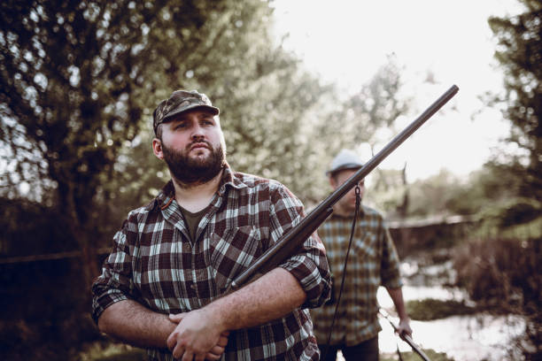 istock Two Hunters Walking in the Forest in Hunting Season 948355120