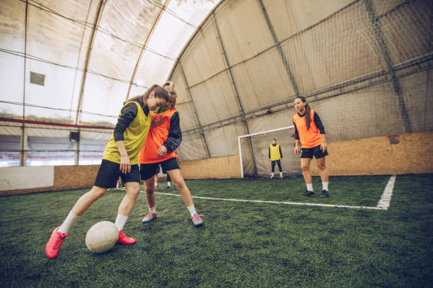 istock Women playing soccer indoors 948355674