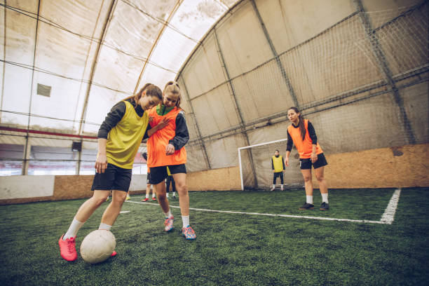 istock Girls playing soccer indoors 948355706