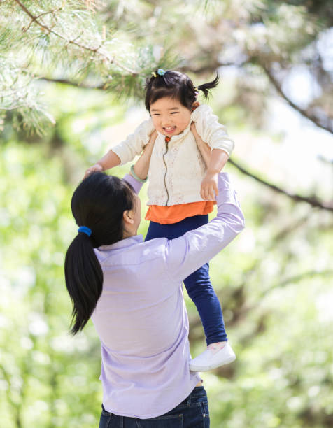 istock Mother lift daughter playing 948358496