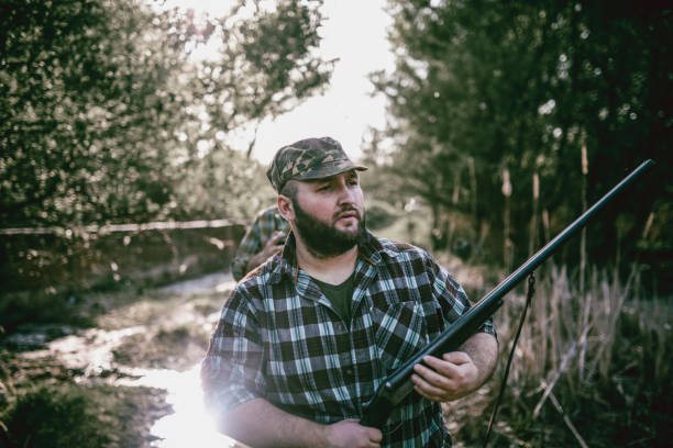 istock Hunters Looking for a Hiding Place in Swamp and Preparing for Hunting 948358962