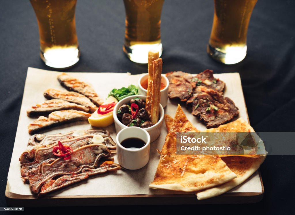 appetizer beer set fried appetizer beer sidedish on cutting board Appetizer Stock Photo