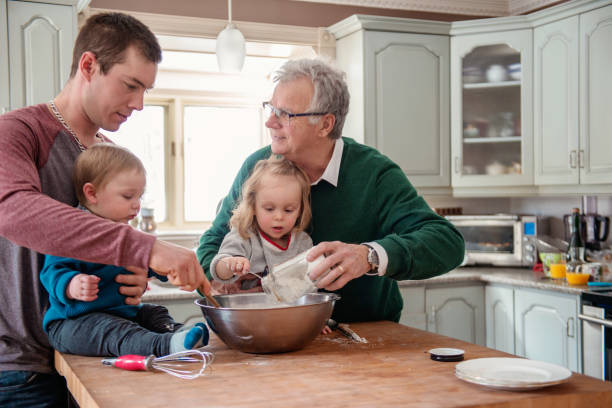 istock Three generation family cooking together including two lovely children 948363242