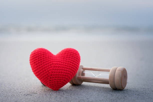istock Red heart on the sand surface,vacation card with copy space 948369128