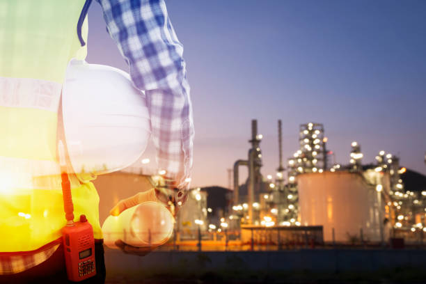 istock Double exposure of engineer in uniform and helmet 948369512