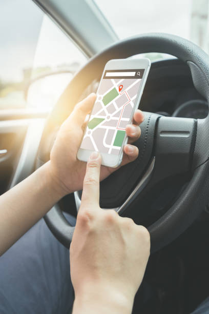 istock Close-up of female hand holding her phone using navigation syste 948369732