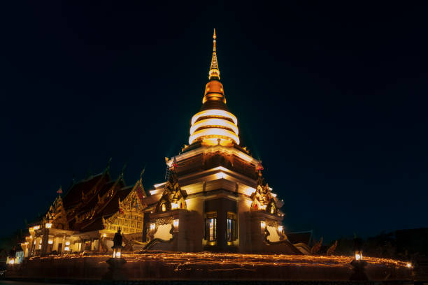 istock People walk with lighted candles to respect Buddha at thailand 948369744