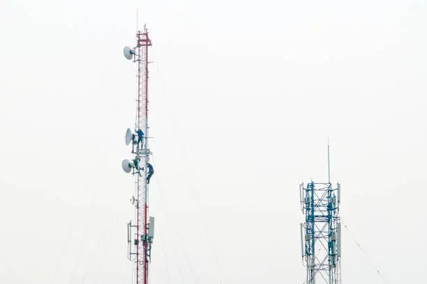 Photo of Signal tower communication and antenna maintenance working worker