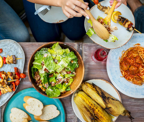 istock Diverse people eating food togethr 948380336