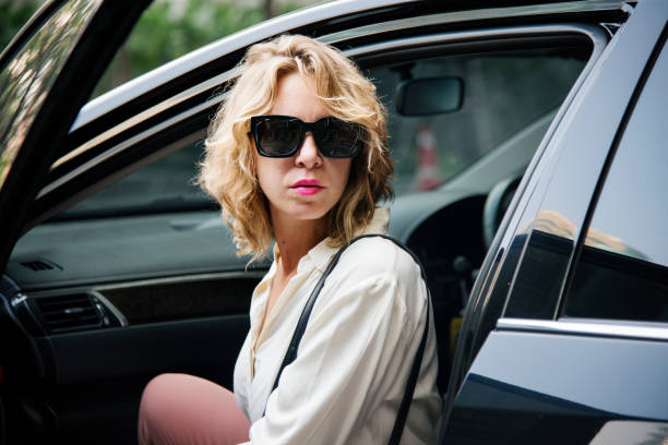 istock Woman getting out from a car 948388566