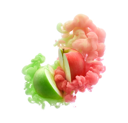 Red and green apples on ink isolated over white background