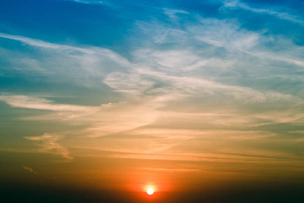 Natural Sunset Sunrise Over Field Or Meadow. Bright Dramatic Sky And Dark Ground. Countryside Landscape Under Scenic Colorful Sky At Sunset Dawn Sunrise. Sun Over Skyline, Horizon. Warm Colours.