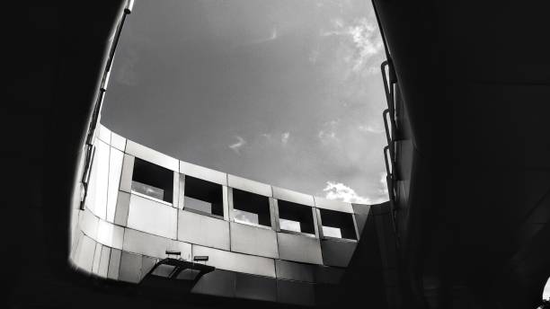Low angle view of modern building against cloudy sky