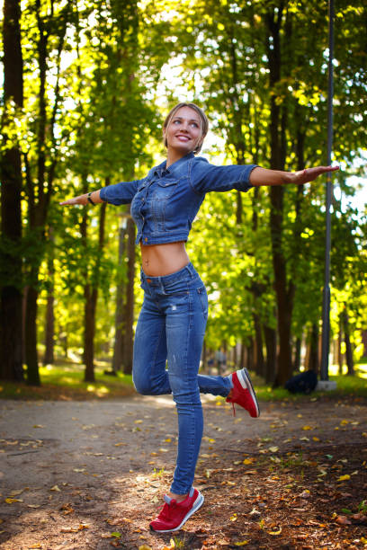 istock Happy slim woman in denim clothes. 948411042
