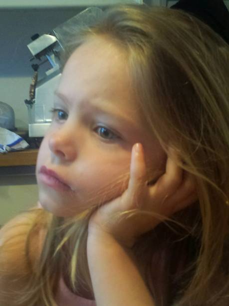istock blonde 5 year old bored face 948411434