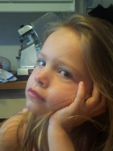 istock blonde 5 year old bored face 948411448