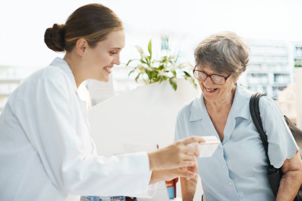 istock Smiling female pharmacist assisting elderly female customer 948412606