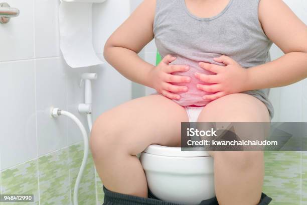 Boy Suffer Stomach And Sit In Toilet Diarrhea Stock Photo - Download Image Now - Child, Diarrhea, Toilet