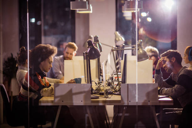 istock Group of entrepreneurs working late at corporate office. 948415256