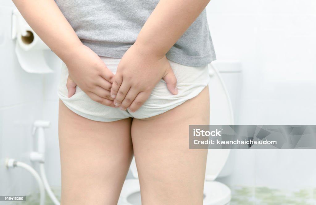 child has Diarrhea Holding his Butt in toilet, child has Diarrhea Holding his Butt in toilet,diarrhea constipation. health and cleanliness concept Child Stock Photo