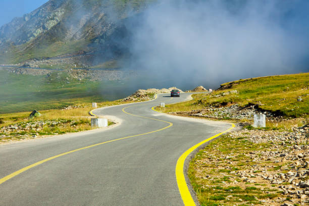 istock curved road in mountain landscape, Transalpina. 948415468