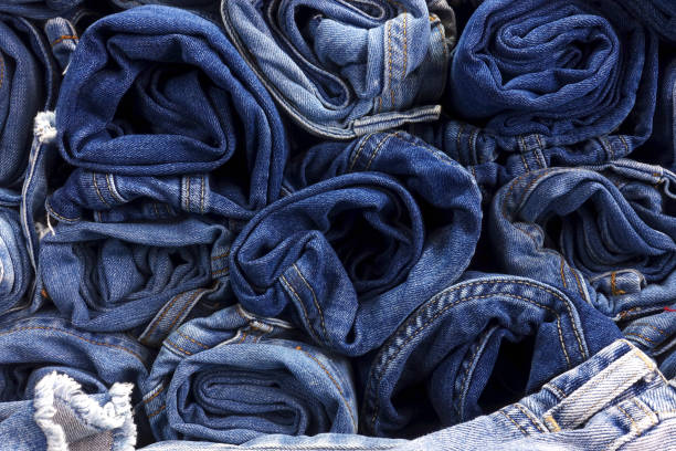 istock Pile of rolled up jeans as background. 948417182