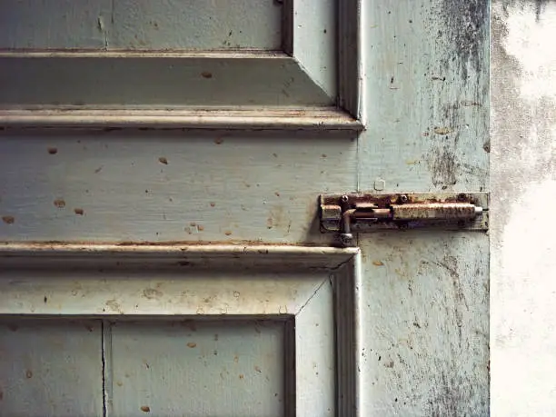 old dirty door bolt latch lock on wooden door