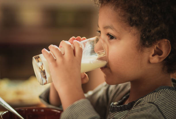 istock Little African American boy drinking fresh milk from a glass. 948423848