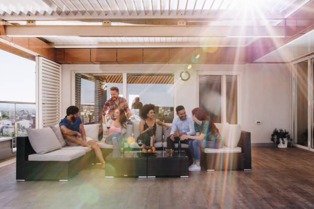 istock Young happy friends talking on a penthouse patio. 948426488