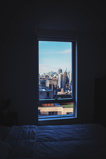 New York, Manhattan cityscape outside a dark room window