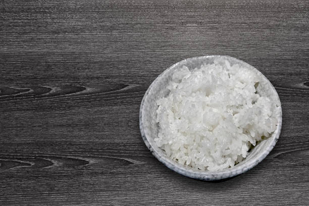 istock isolated with clipping path on weeden texture - plain steamed rice served on ceramic stone bowl 948433816