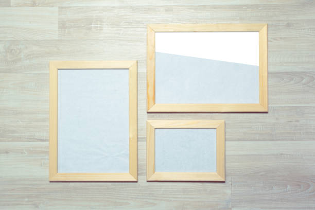 istock photo frames on the wooden wall 948442626