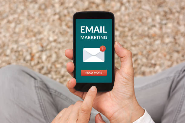 istock Hands holding smart phone with email marketing concept on screen 948442930