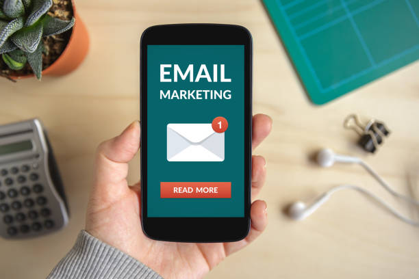 istock Hand holding smart phone with email marketing concept on screen 948442944