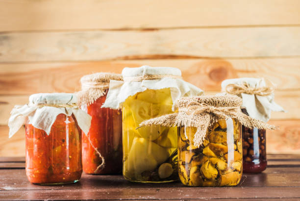 istock Preserved vegetables on wooden background 948443936