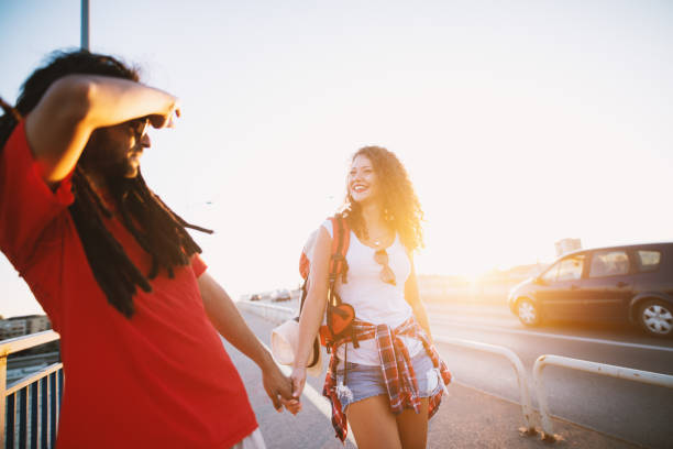 istock Beautiful couple holding hands cheering while having fun on a vacation. 948443962