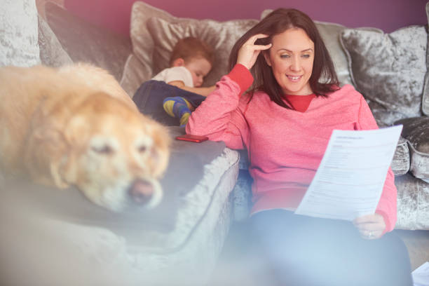 istock Young mother smiling reading bank statement 948445152